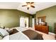 Bright bedroom featuring a barn door and a view into the en suite bathroom at 34942 Wagon Wheel Trl, Elizabeth, CO 80107