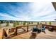 Spacious outdoor deck with seating, a grill, and picturesque landscape views, perfect for enjoying the outdoors at 34942 Wagon Wheel Trl, Elizabeth, CO 80107