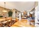 Open-concept dining room with hardwood floors flowing into the living room and fireplace at 34942 Wagon Wheel Trl, Elizabeth, CO 80107
