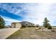 Attractive one-story home with a two-car garage, a well-manicured lawn, and beautiful landscaping at 34942 Wagon Wheel Trl, Elizabeth, CO 80107