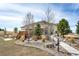 Charming exterior of a home with a wooden deck, landscaped yard and a inviting sidewalk at 34942 Wagon Wheel Trl, Elizabeth, CO 80107