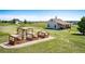 Beautifully landscaped yard featuring raised garden beds and a charming outbuilding at 34942 Wagon Wheel Trl, Elizabeth, CO 80107