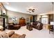 Cozy living room features plush seating, ceiling fan, and stone fireplace at 34942 Wagon Wheel Trl, Elizabeth, CO 80107