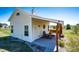 View of outbuilding with covered porch, rocking chairs, and well-maintained exterior at 34942 Wagon Wheel Trl, Elizabeth, CO 80107