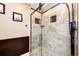 Stylish shower features decorative tile accents, a glass door, and modern fixtures at 34942 Wagon Wheel Trl, Elizabeth, CO 80107