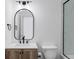 This bathroom offers a modern vanity with oval mirror, pendant lighting, and shower with glass door at 11488 E 25Th Dr, Aurora, CO 80010