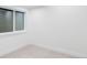 An empty bedroom awaits its next occupant, offering neutral carpet, a large window and bright light at 11488 E 25Th Dr, Aurora, CO 80010