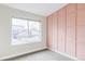 Bedroom with large window, neutral carpet, and a stylish accent wall at 11488 E 25Th Dr, Aurora, CO 80010