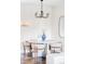 Bright dining nook featuring modern light fixture, hardwood floors, a round table, and seating for four at 11488 E 25Th Dr, Aurora, CO 80010