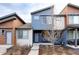 Modern home with blue and white siding, gray trim, and a well-maintained front yard offers curb appeal at 11488 E 25Th Dr, Aurora, CO 80010