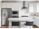 Bright kitchen with white cabinets, stainless steel appliances, subway tile backsplash, and quartz countertops at 11488 E 25Th Dr, Aurora, CO 80010