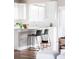 Modern kitchen with white cabinets, subway tile backsplash, and a breakfast bar for casual dining at 11488 E 25Th Dr, Aurora, CO 80010