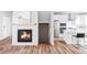 Open-concept layout with fireplace and view into the kitchen showcasing functionality and design at 11488 E 25Th Dr, Aurora, CO 80010