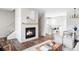 Open-concept layout features a fireplace, stairs, and view into the kitchen, creating a warm and inviting space at 11488 E 25Th Dr, Aurora, CO 80010