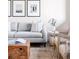 Cozy living room featuring hardwood floors, modern furnishings, and a decorative coffee table at 11488 E 25Th Dr, Aurora, CO 80010