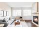Bright and airy living room features a decorative fireplace, dark hardwood floors, and an open floor plan at 11488 E 25Th Dr, Aurora, CO 80010