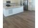 An open kitchen features wood floors, stainless steel appliances and white cabinets at 8859 Waterleaf Ln, Littleton, CO 80125