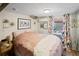 Cozy basement bedroom with a plush pink comforter and floral curtains at 2640 S York St, Denver, CO 80210