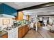 Basement kitchen with wood cabinets, white appliances, and teal accents at 2640 S York St, Denver, CO 80210