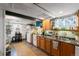 Basement kitchen with teal cabinets and wood flooring at 2640 S York St, Denver, CO 80210