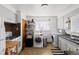 Galley kitchen with white cabinets and appliances at 2640 S York St, Denver, CO 80210