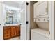 Bathroom showcasing updated vanity, sink, mirror and stackable washer and dryer at 9283 E Arbor Cir # C, Englewood, CO 80111