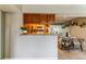Dining Area featuring an open kitchen with wood cabinets and modern lighting fixtures at 9283 E Arbor Cir # C, Englewood, CO 80111