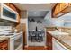 Kitchen featuring wood cabinets, appliances, and an open view to the dining area at 9283 E Arbor Cir # C, Englewood, CO 80111