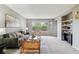 Cozy living room with large windows and built-in shelving offers comfortable and stylish seating at 9283 E Arbor Cir # C, Englewood, CO 80111