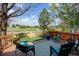 Relax on the spacious back deck with comfortable seating and serene views of the lush green space at 2937 W Yarrow Cir, Superior, CO 80027