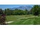 Expansive backyard featuring a lush lawn and picturesque views of the mountains in the background at 2937 W Yarrow Cir, Superior, CO 80027