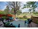 The backyard deck offers peaceful views with chairs and an outdoor rug; perfect for relaxing or entertaining at 2937 W Yarrow Cir, Superior, CO 80027