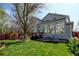 Well-maintained backyard with a patio, lush green lawn, and mature trees, perfect for outdoor living at 2937 W Yarrow Cir, Superior, CO 80027