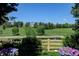 Picturesque backyard view with a tranquil pond, lush greenery, and a charming wooden fence at 2937 W Yarrow Cir, Superior, CO 80027