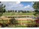 Scenic backyard view with a serene pond, lush greenery, and a wooden fence for privacy at 2937 W Yarrow Cir, Superior, CO 80027