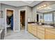 Bright bathroom featuring a double vanity, neutral wall colors, and a view of the closet and toilet area at 2937 W Yarrow Cir, Superior, CO 80027