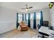Bright room with carpet, three windows with blue drapes, and a cozy chair and desk setup at 2937 W Yarrow Cir, Superior, CO 80027