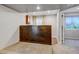 Cozy bonus room features a wooden accent wall, neutral carpet, and natural light through an adjacent window at 2937 W Yarrow Cir, Superior, CO 80027