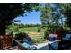 Charming deck view with wicker chairs, vibrant flower pots, and scenic views of the pond and mountains at 2937 W Yarrow Cir, Superior, CO 80027