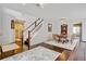 Bright dining area featuring hardwood floors, a modern chandelier, and an adjacent staircase at 2937 W Yarrow Cir, Superior, CO 80027