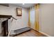 Hardwood-floor exercise room featuring a treadmill, wall clock, and natural light, great for fitness enthusiasts at 2937 W Yarrow Cir, Superior, CO 80027