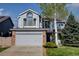 Charming two-story home with a well-maintained lawn, mature trees, and an attached two-car garage at 2937 W Yarrow Cir, Superior, CO 80027