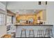 Modern kitchen with stainless steel appliances, a breakfast bar with stools, and an adjacent dining area at 2937 W Yarrow Cir, Superior, CO 80027