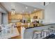 Bright kitchen features wooden cabinets, stainless steel appliances, island, and breakfast bar at 2937 W Yarrow Cir, Superior, CO 80027