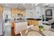 Open-concept kitchen with an island, stainless steel appliances, and seamless flow to the living area at 2937 W Yarrow Cir, Superior, CO 80027