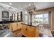 Well-lit kitchen with an island, stainless steel appliances, and an adjacent breakfast nook with a backyard view at 2937 W Yarrow Cir, Superior, CO 80027