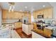 Bright kitchen features wooden cabinets, stainless steel appliances, island and hardwood floors at 2937 W Yarrow Cir, Superior, CO 80027