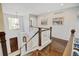 Landing area featuring wooden floors and banister, and view of the front door at 2937 W Yarrow Cir, Superior, CO 80027