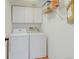 Bright laundry room equipped with a washer, dryer, and overhead storage cabinets for convenience at 2937 W Yarrow Cir, Superior, CO 80027