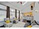 Open-concept living room with high ceilings, large windows, fireplace, and seamless connection to the kitchen bar at 2937 W Yarrow Cir, Superior, CO 80027